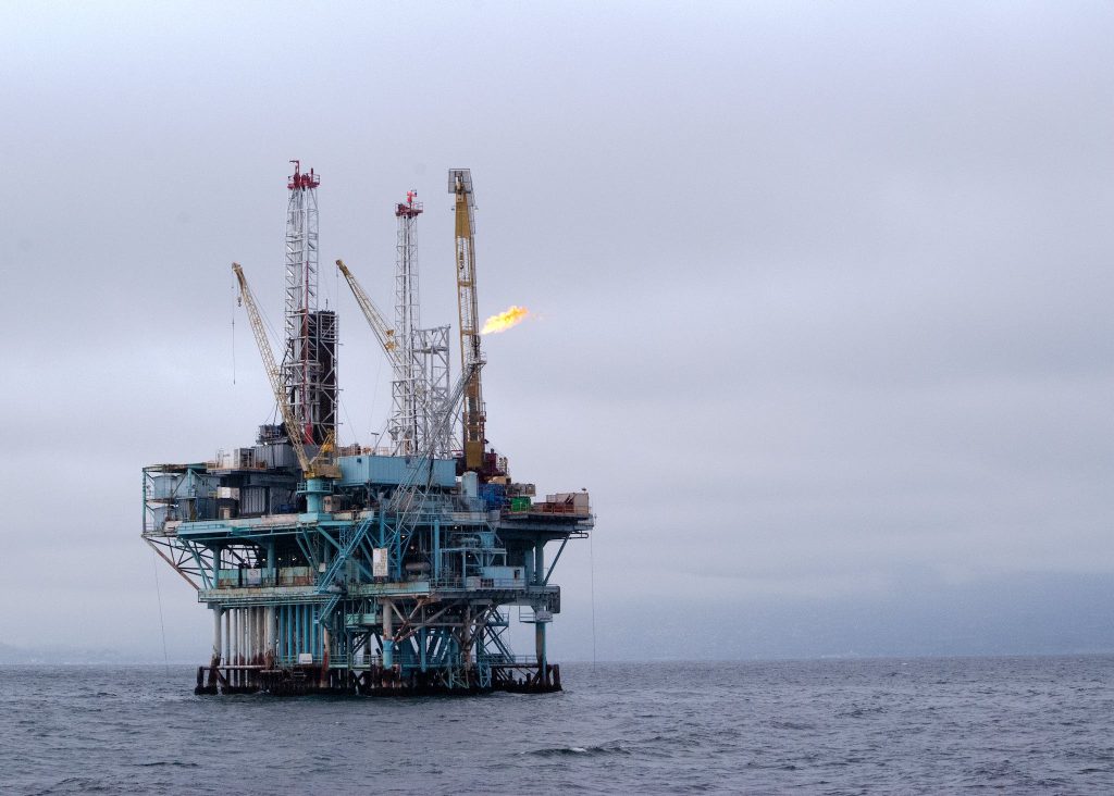 An Oil Rig in Middle of Body of Water