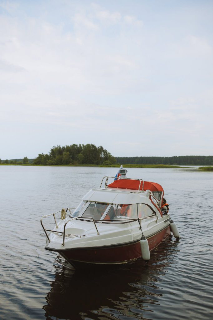 White and Red Boat on Water